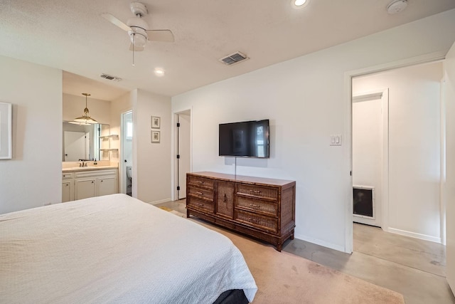 bedroom featuring sink, connected bathroom, and ceiling fan