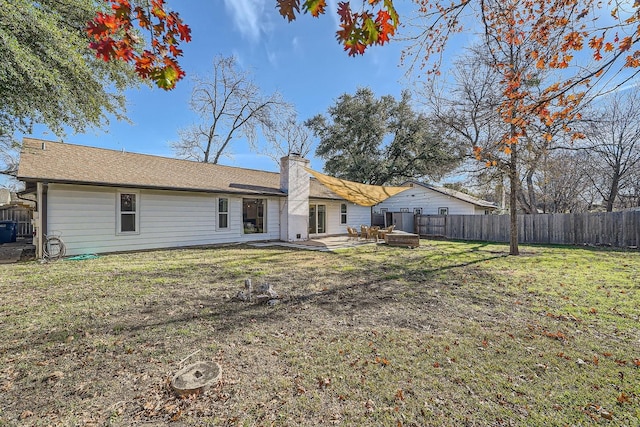 rear view of property with a yard