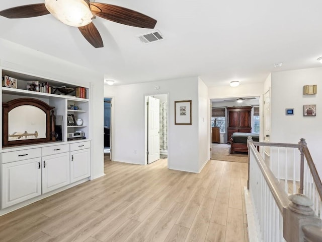 living room featuring ceiling fan and light hardwood / wood-style flooring