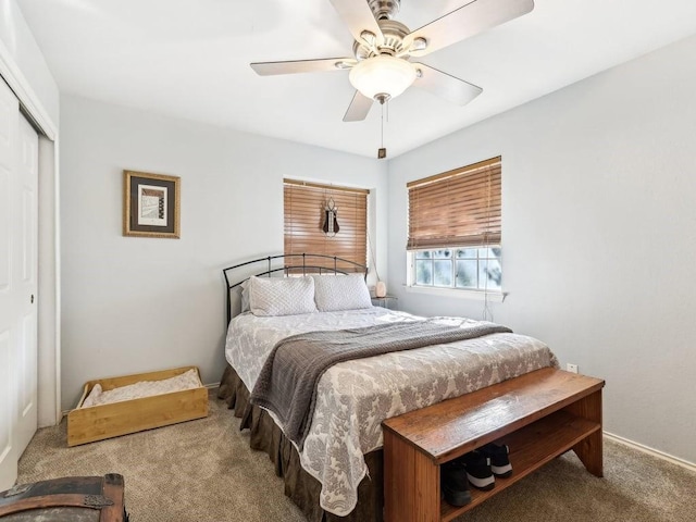 carpeted bedroom with a closet and ceiling fan