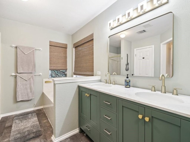 bathroom with vanity and a bathtub