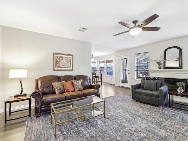 living room with ceiling fan and wood-type flooring