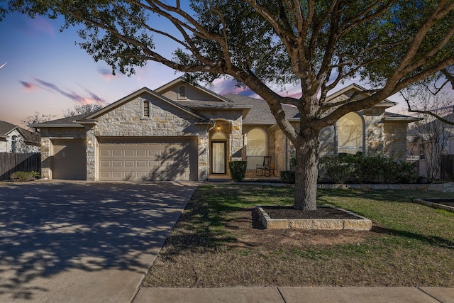 view of front facade featuring a garage and a lawn