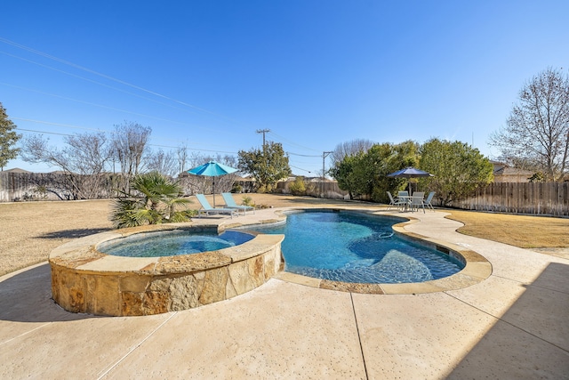 view of pool featuring a patio and an in ground hot tub