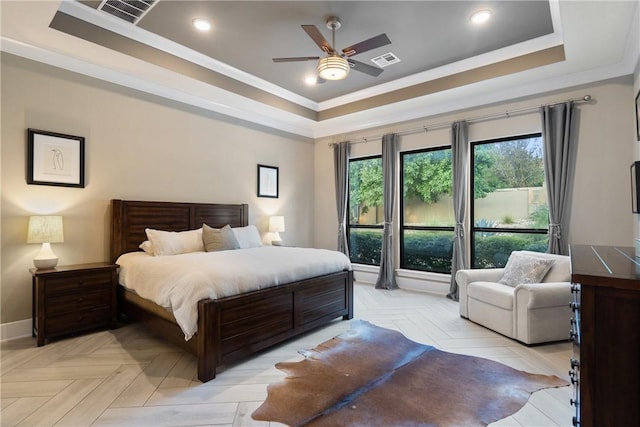 bedroom with ceiling fan, crown molding, a raised ceiling, and light parquet floors