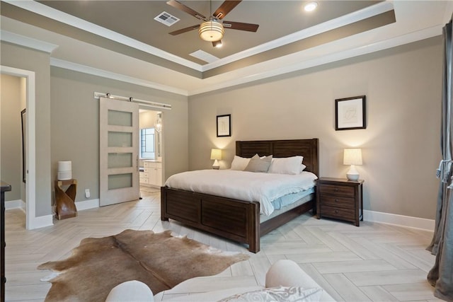 bedroom with connected bathroom, crown molding, ceiling fan, light parquet flooring, and a barn door