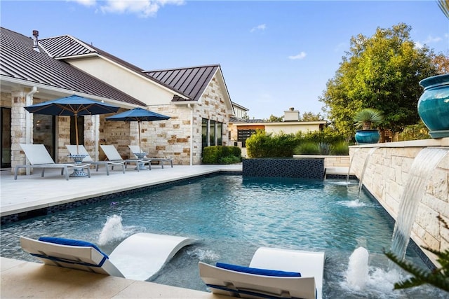 view of swimming pool with a patio area and pool water feature