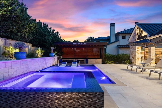 107 Bisset Ct, Austin, TX 78738 - pool at dusk with an in ground hot tub, a patio area, and a fenced in pool