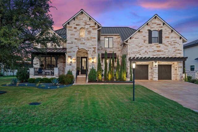 107 Bisset Ct, Austin, TX 78738 - view of front facade with stone siding, a standing seam roof, a front lawn, and metal roof