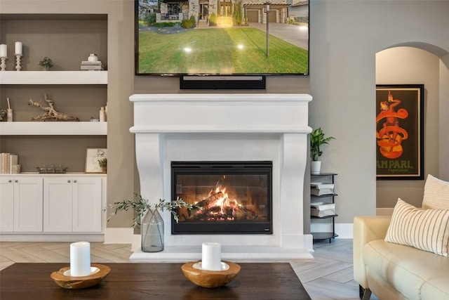 107 Bisset Ct, Austin, TX 78738 - interior space with arched walkways and a glass covered fireplace