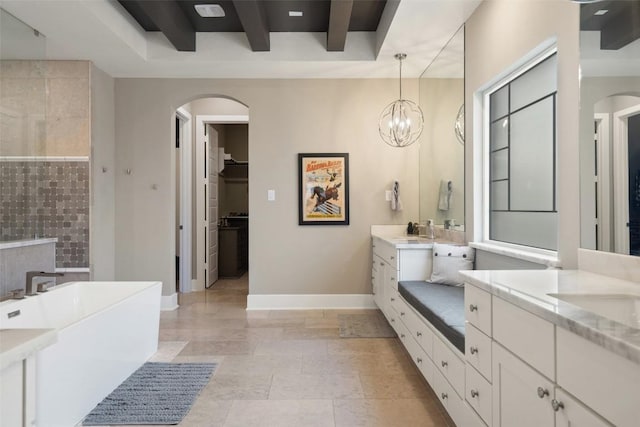107 Bisset Ct, Austin, TX 78738 - bathroom featuring a soaking tub, vanity, a spacious closet, a chandelier, and a raised ceiling