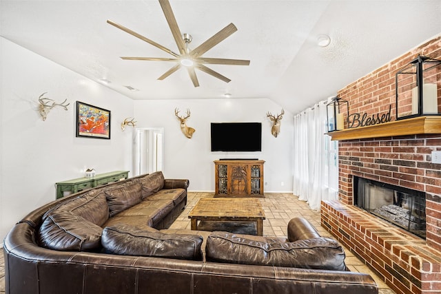 living room featuring a brick fireplace, a textured ceiling, vaulted ceiling, and ceiling fan