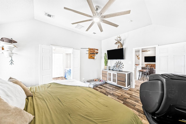 bedroom featuring hardwood / wood-style flooring, vaulted ceiling, and ceiling fan