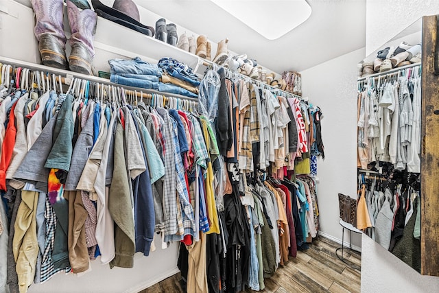 walk in closet with hardwood / wood-style flooring