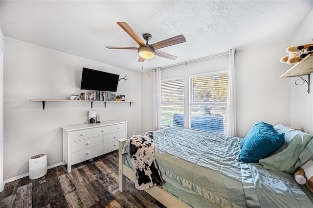 bedroom featuring a textured ceiling, dark hardwood / wood-style floors, and ceiling fan