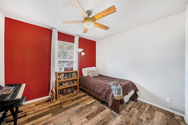 bedroom with ceiling fan and dark hardwood / wood-style floors