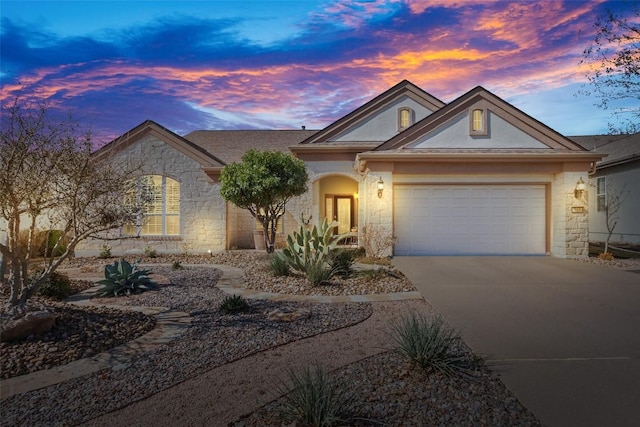 215 Goose Island Dr, Georgetown, TX 78633 - view of front of house featuring stone siding, driveway, an attached garage, and stucco siding