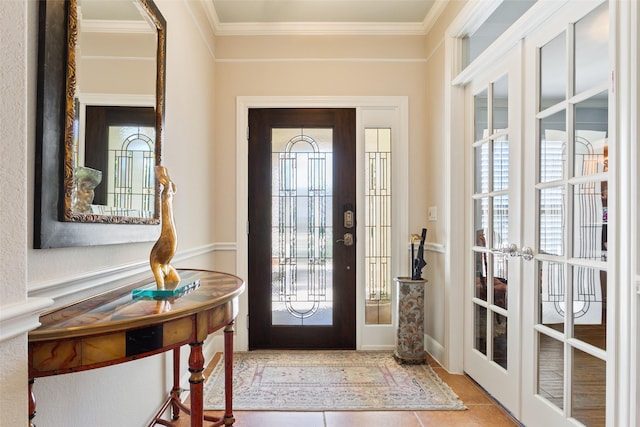 tiled foyer entrance featuring french doors and ornamental molding