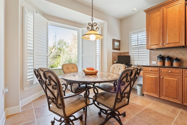 tiled dining room featuring plenty of natural light