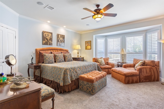 carpeted bedroom with ornamental molding and ceiling fan