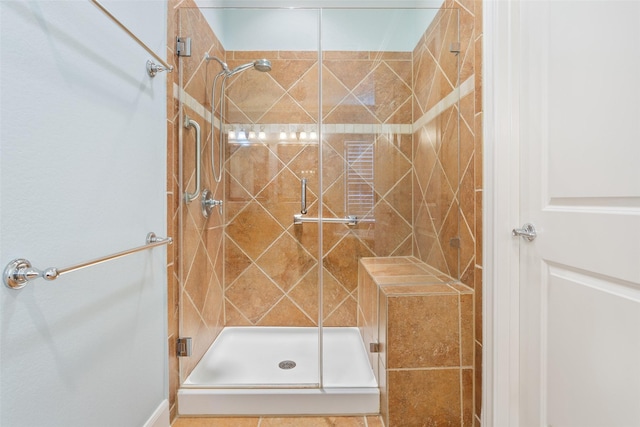 bathroom with a shower with door