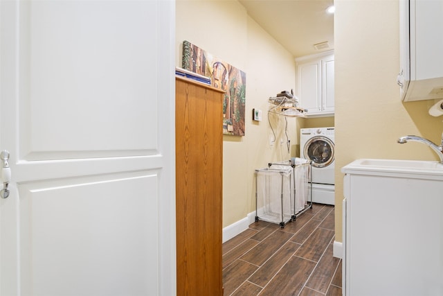 laundry area with cabinets, washer / dryer, and sink