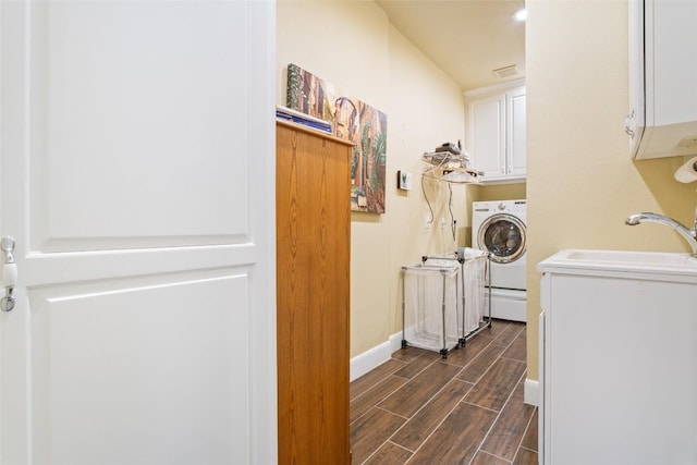 215 Goose Island Dr, Georgetown, TX 78633 - washroom with washer / clothes dryer, cabinet space, wood finish floors, and baseboards