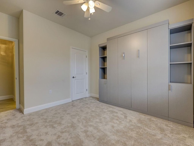 unfurnished bedroom with ceiling fan and light carpet