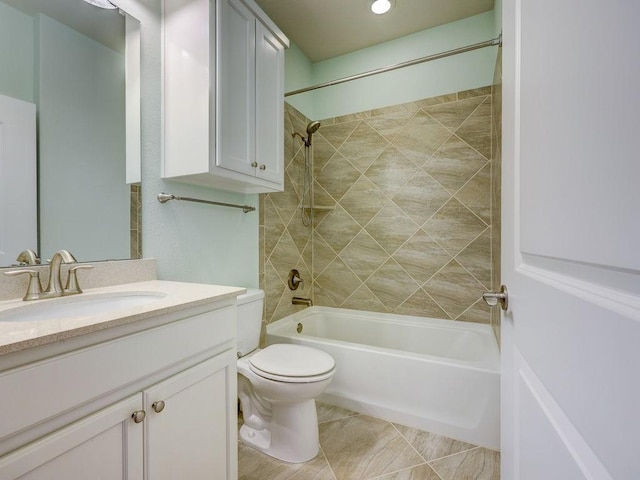 full bathroom featuring tiled shower / bath combo, vanity, tile patterned flooring, and toilet