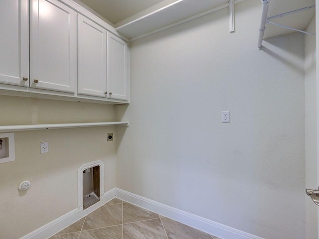 laundry area with gas dryer hookup, hookup for a washing machine, cabinets, light tile patterned flooring, and hookup for an electric dryer