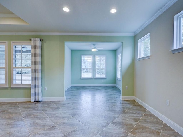 empty room featuring a wealth of natural light, ornamental molding, and ceiling fan