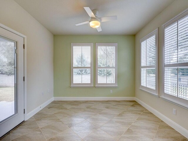 tiled empty room with ceiling fan