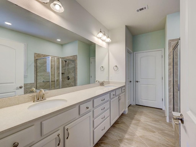 bathroom with vanity, tile patterned floors, and a shower with door