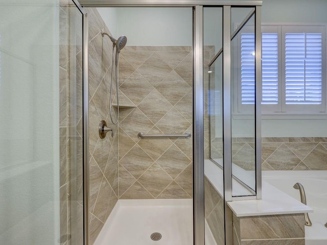 bathroom featuring separate shower and tub