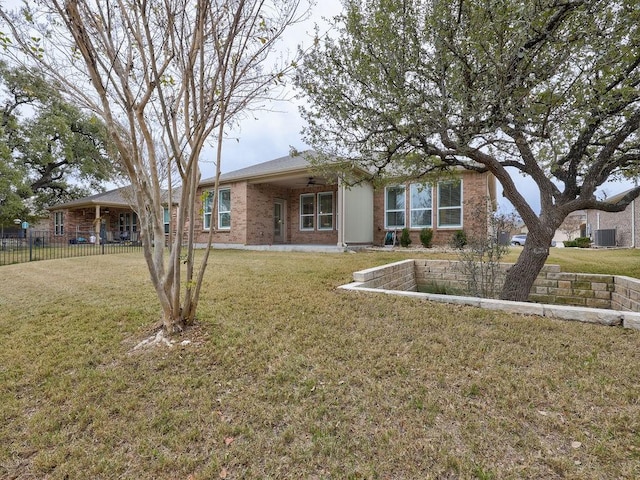 ranch-style home featuring a front yard and ceiling fan