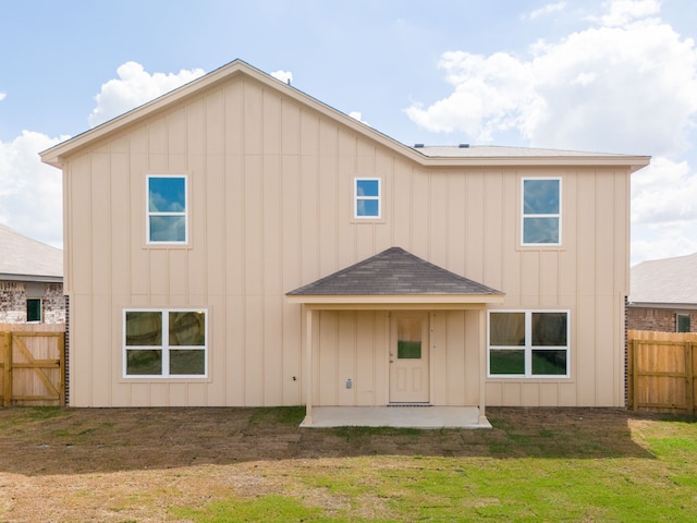 rear view of property with a yard and a patio area