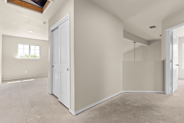 corridor with lofted ceiling