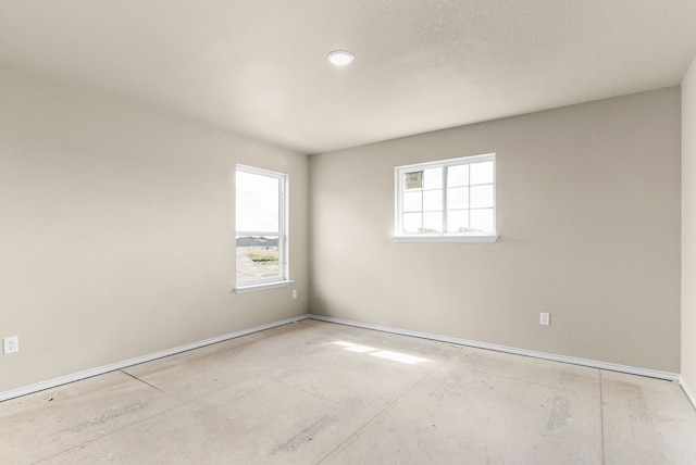 unfurnished room featuring plenty of natural light