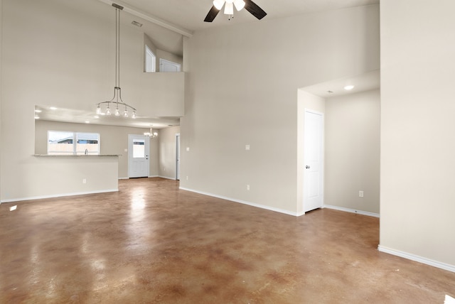 unfurnished living room with high vaulted ceiling, ceiling fan with notable chandelier, and concrete floors