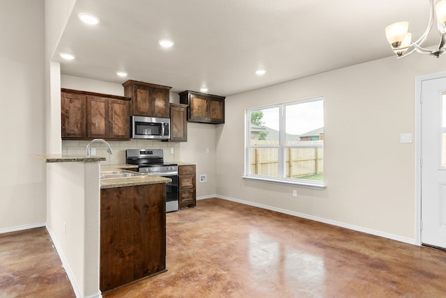 kitchen featuring dark brown cabinetry, sink, stainless steel appliances, light stone countertops, and decorative backsplash