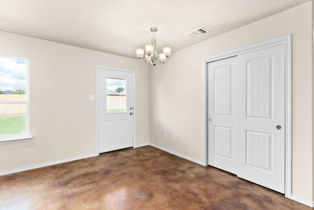 foyer with a chandelier