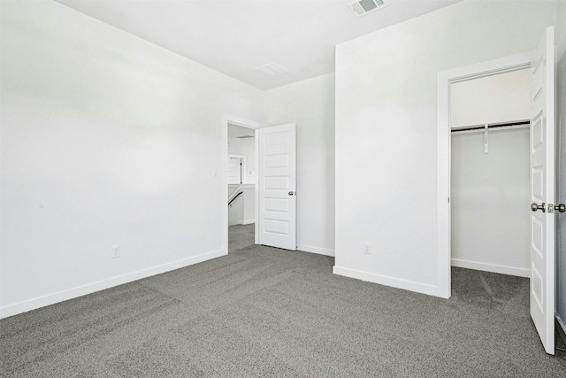 143 Big Pine Creek Ln, Bastrop, TX 78602 - unfurnished bedroom with carpet, baseboards, a closet, and a walk in closet