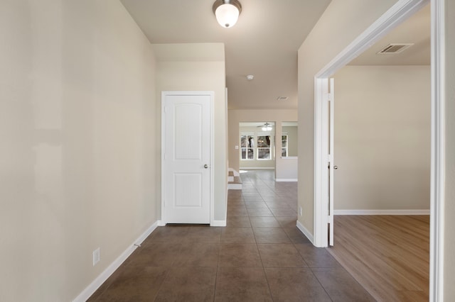 corridor with dark tile patterned floors