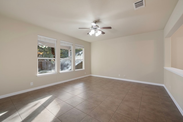 spare room featuring tile patterned flooring and ceiling fan