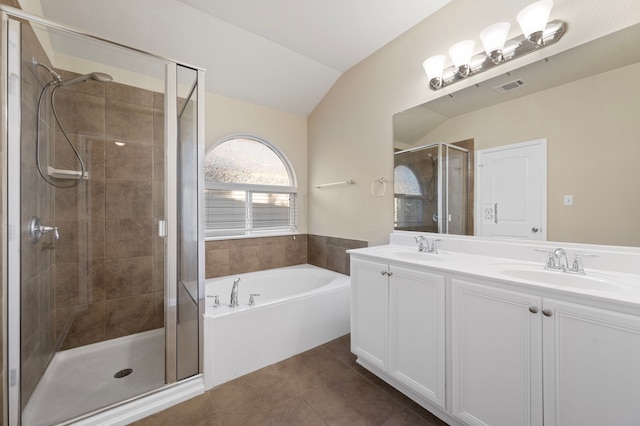 bathroom featuring vanity, plus walk in shower, tile patterned flooring, and vaulted ceiling