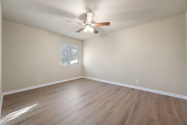 empty room with ceiling fan and light wood-type flooring