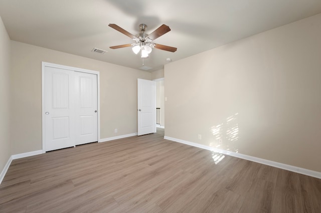 unfurnished bedroom with a closet, ceiling fan, and light hardwood / wood-style flooring