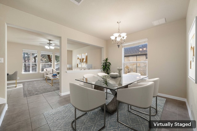 dining space featuring ceiling fan with notable chandelier and tile patterned floors