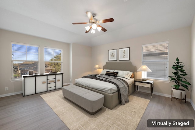 bedroom featuring ceiling fan and light hardwood / wood-style flooring