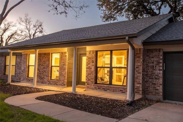 exterior entry at dusk with a garage